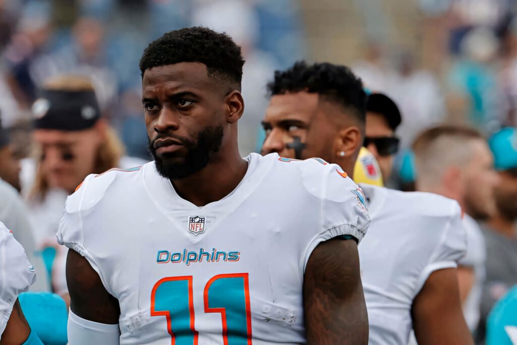 Devante Parker in Miami Dolphins aqua and white uniform on sidelines showing game day focus Wallpaper