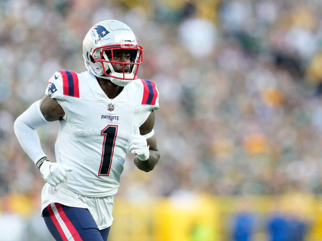 Devante Parker New England Patriots number 1 in white navy uniform focused in action on field Wallpaper