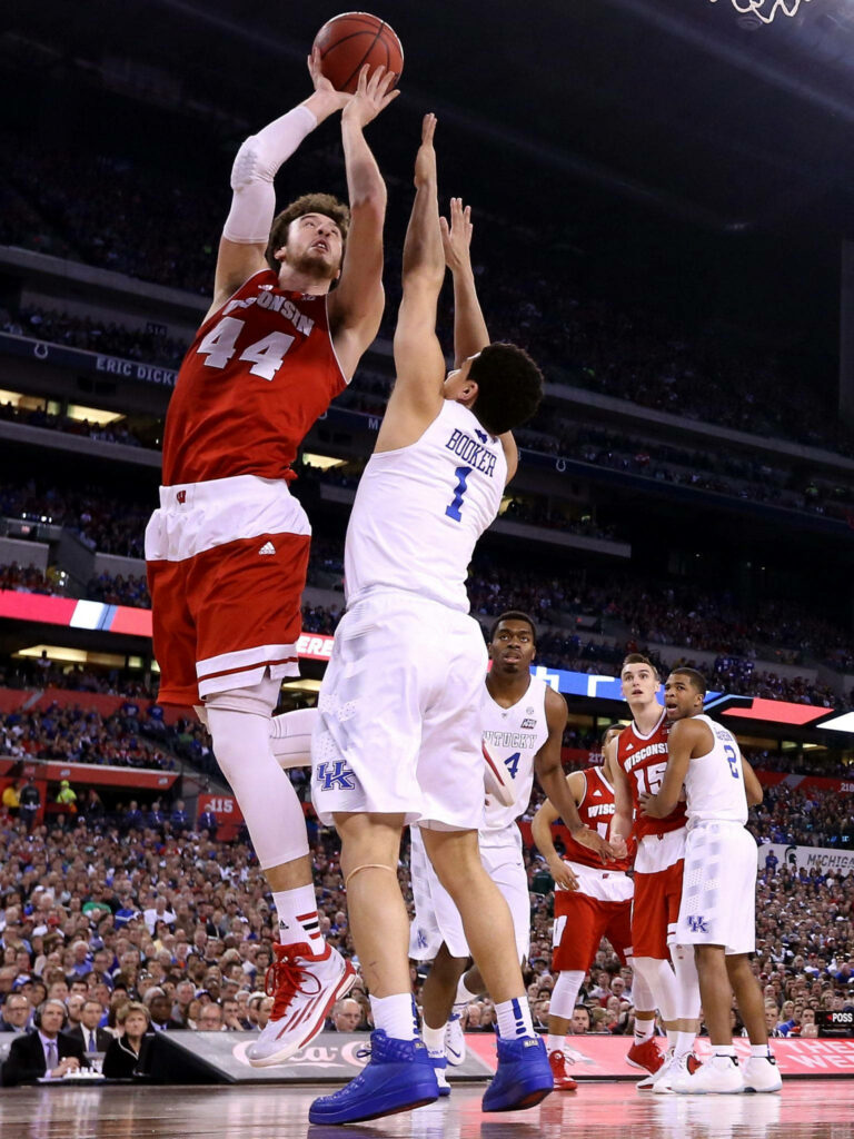 Devin Booker in Kentucky blue number 1 defends Wisconsin shooter intense college basketball game Wallpaper