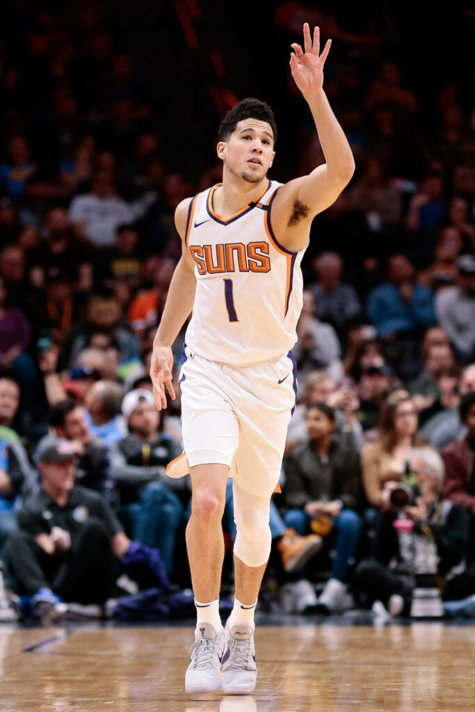 Devin Booker Phoenix Suns celebrating three-point shot dynamic basketball action wallpaper