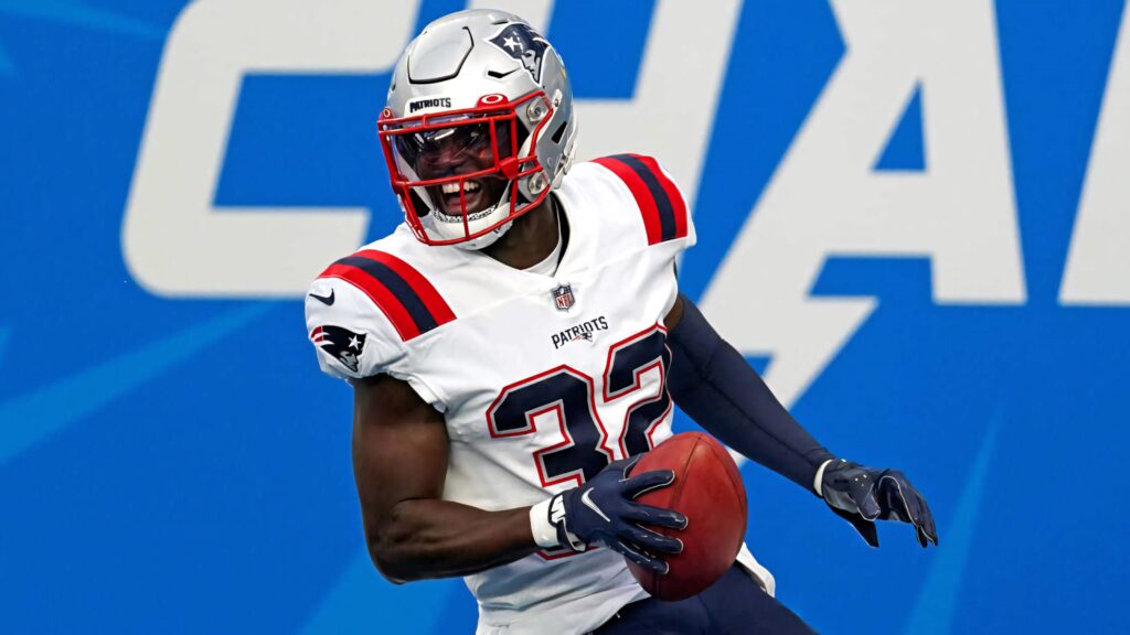 Devin McCourty in New England Patriots uniform catching football showing athleticism and focus Wallpaper