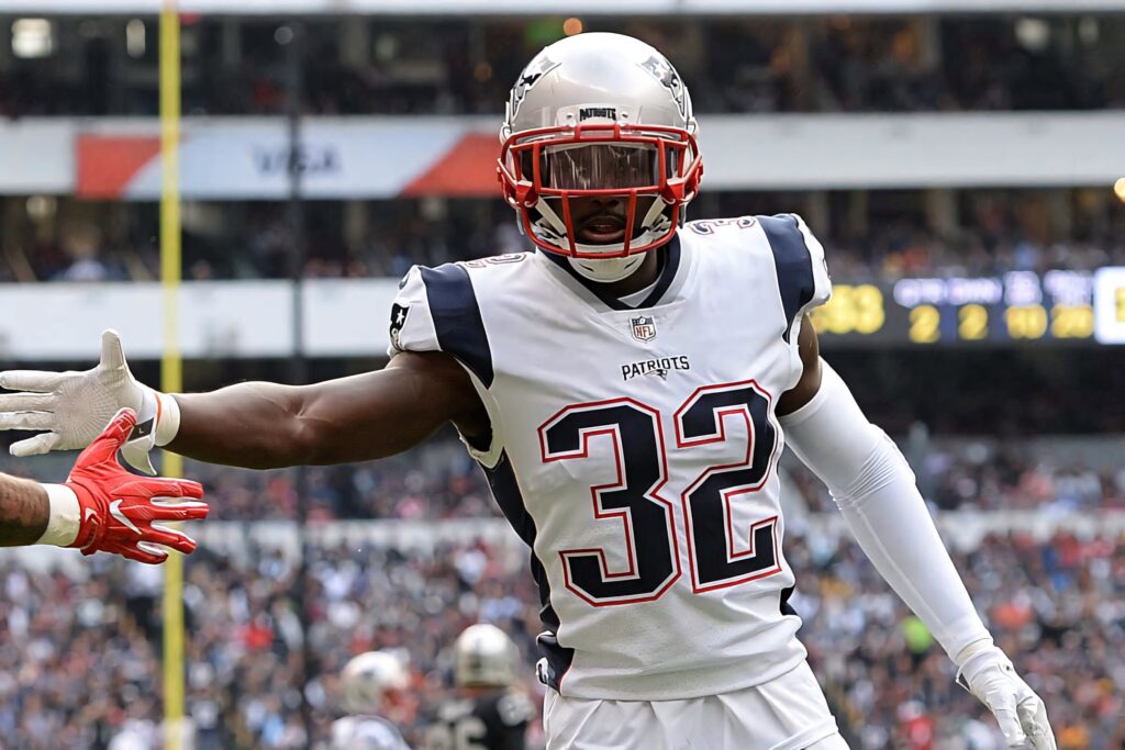 Devin McCourty New England Patriots number 32 intense game day action wallpaper background