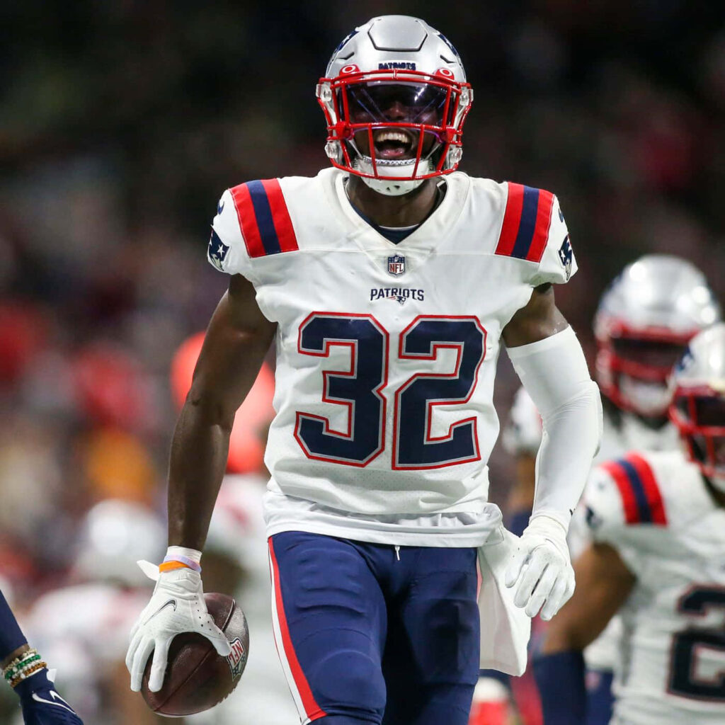 Devin McCourty in white Patriots uniform focused in action during stadium football game wallpaper