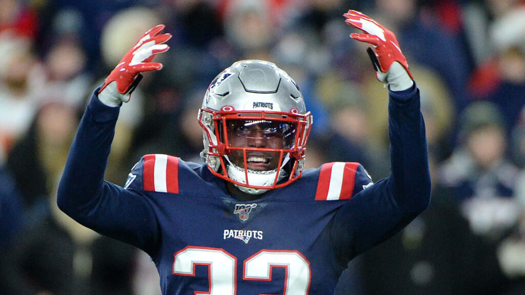 Devin McCourty in Patriots navy and red uniform passionately reacting on field game day wallpaper