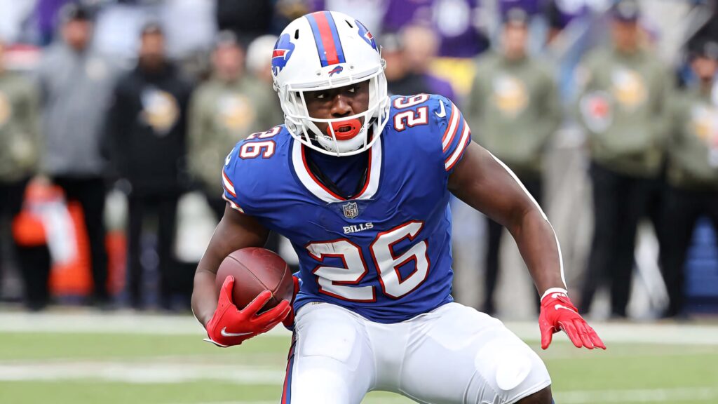 Devin Singletary Buffalo Bills in blue red uniform running with football dynamic stadium wallpaper