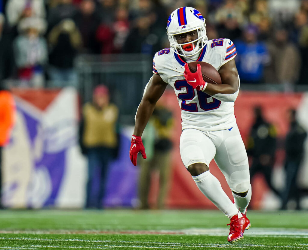 Devin Singletary Buffalo Bills running back mid-action charging downfield in white blue uniform Wallpaper