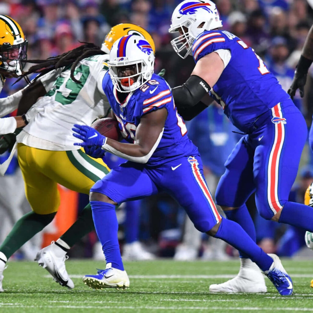 Devin Singletary Buffalo Bills breaking defense vibrant team colors intense football action wallpaper