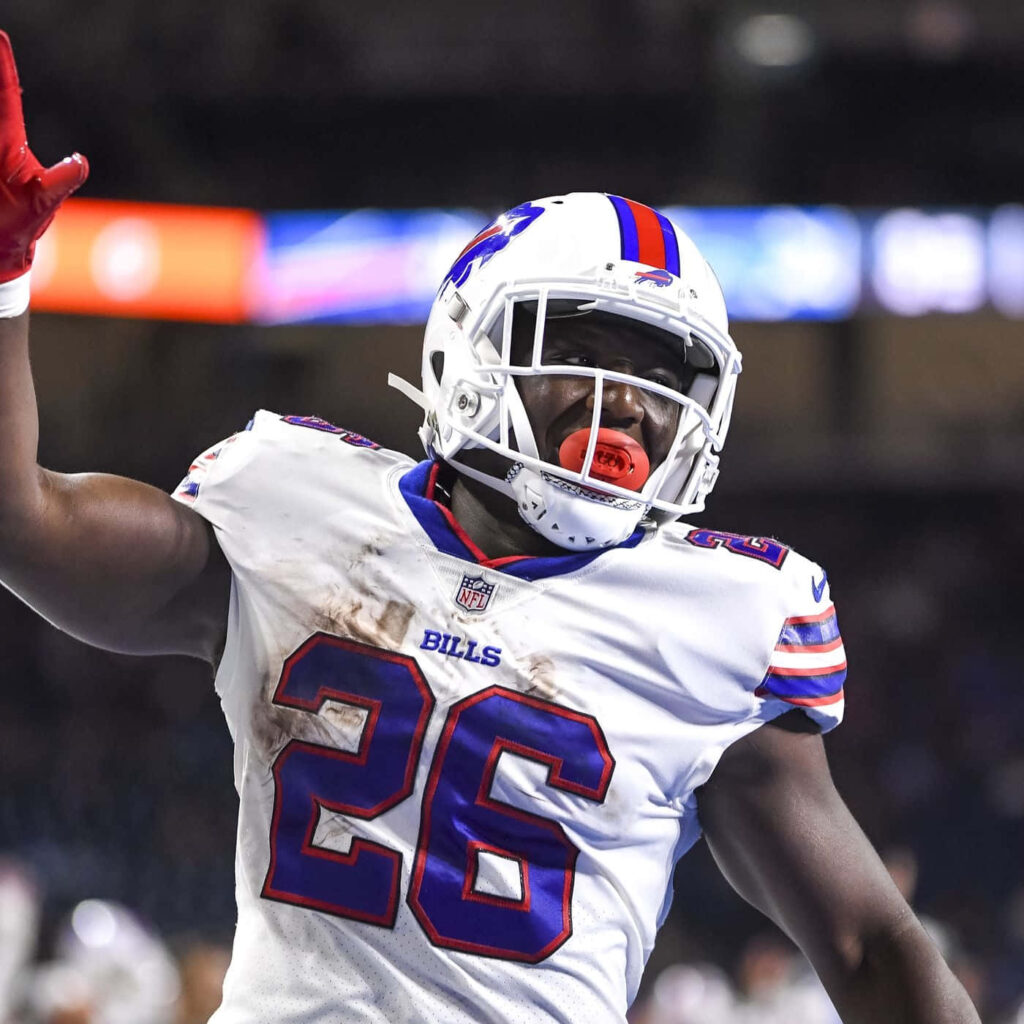Devin Singletary Buffalo Bills celebrating in white jersey number 26 with stadium lights background Wallpaper