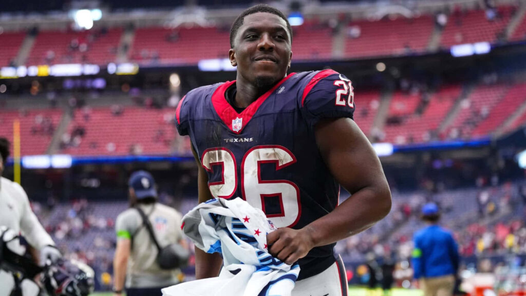 Devin Singletary Houston Texans number 26 jersey on stadium field vibrant game day energy wallpaper