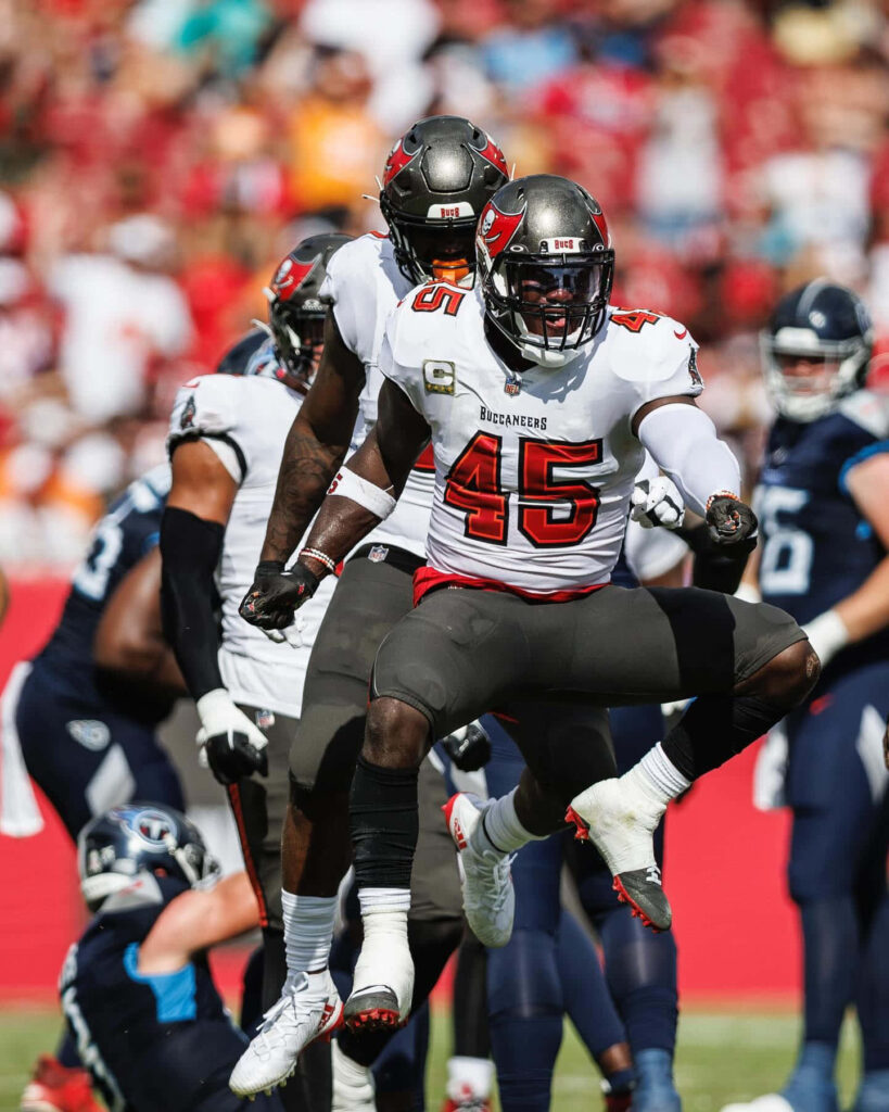 Devin White Buccaneers linebacker in intense action on field wearing red white and pewter jersey Wallpaper