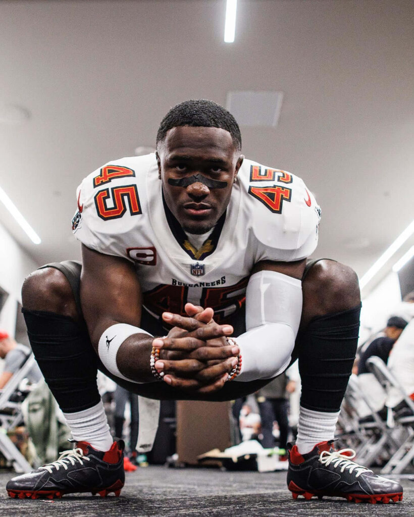 Devin White Tampa Bay Buccaneers linebacker focused in locker room intense football prep wallpaper