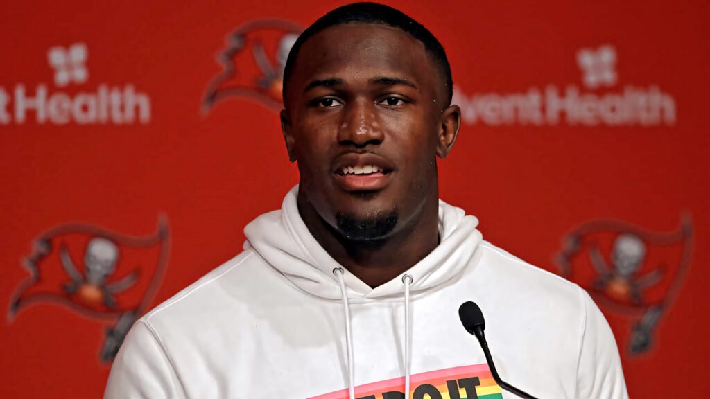 Devin White in white hoodie at Tampa Bay Buccaneers press conference red background wallpaper
