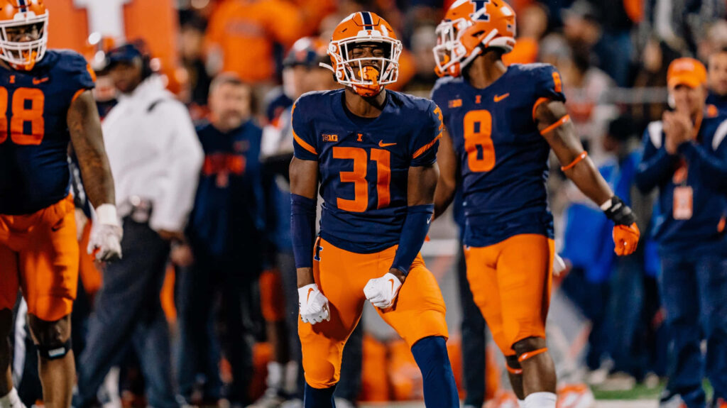 Devon Witherspoon in Illinois Football navy orange uniform number 31 focused on field play Wallpaper