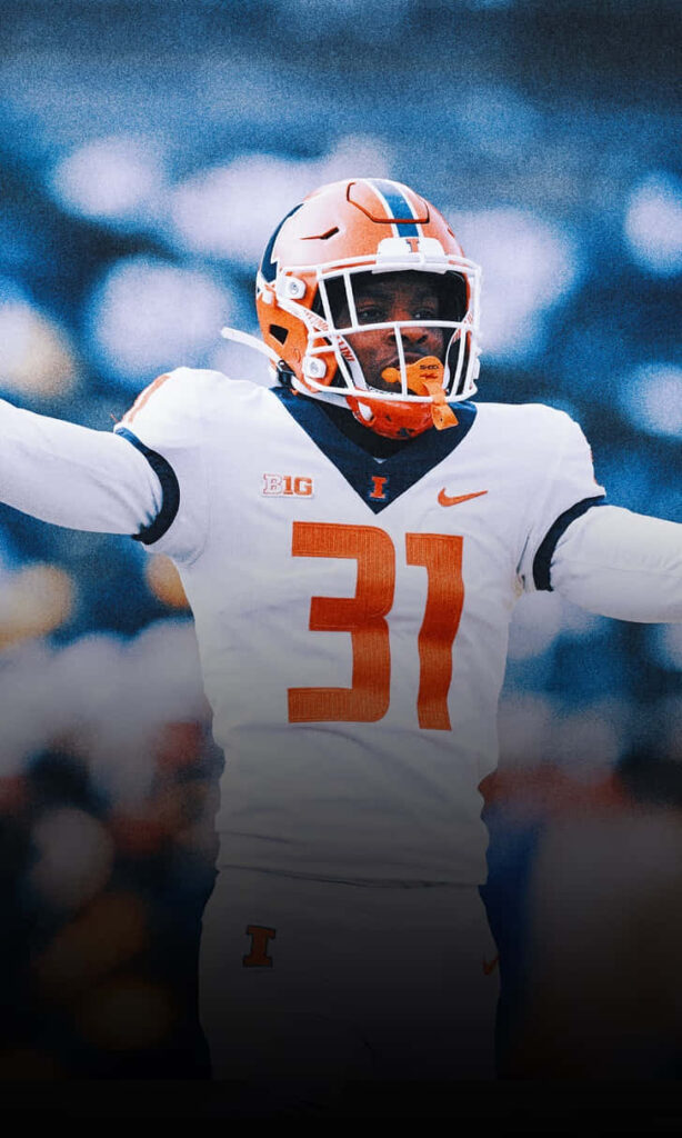 Devon Witherspoon Illinois football uniform number 31 celebrates with arms raised vibrant wallpaper