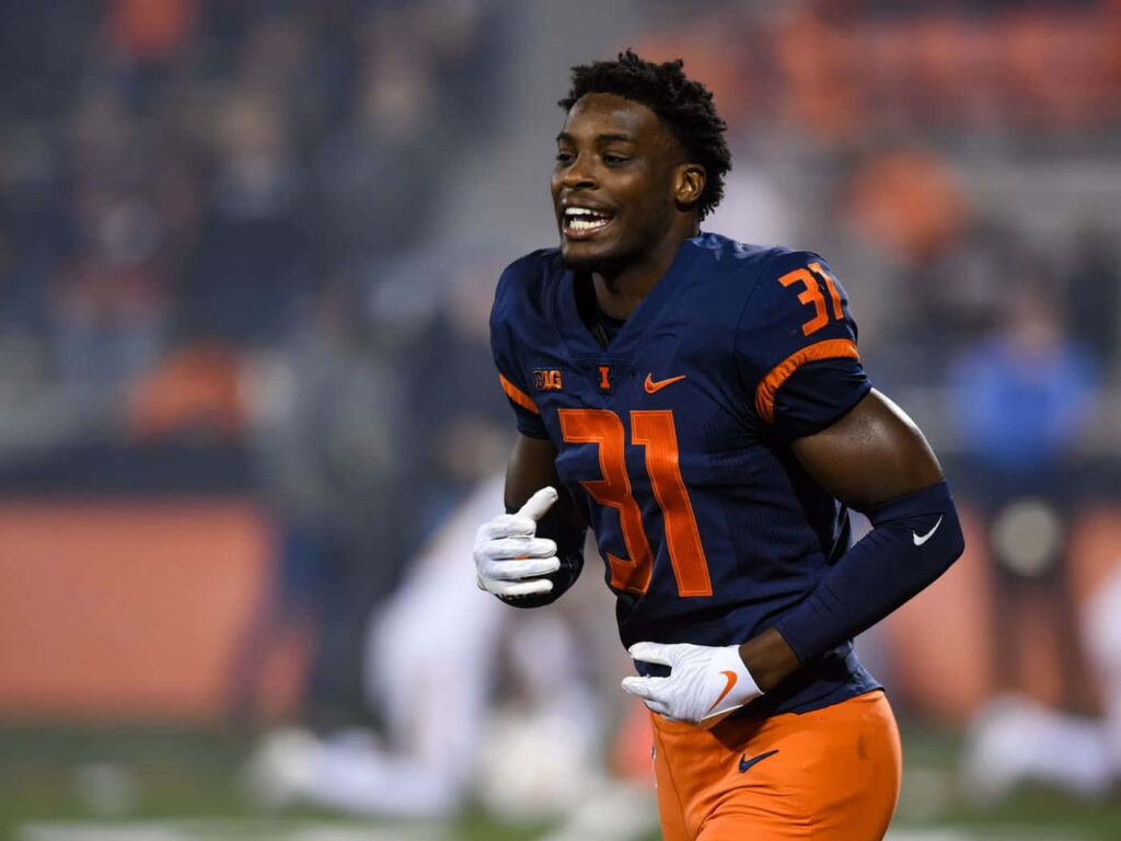 Devon Witherspoon in navy orange number 31 jersey smiling on football field vibrant wallpaper