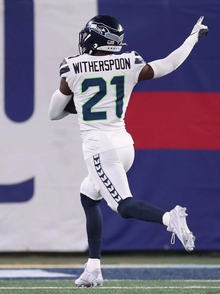 Devon Witherspoon Seahawks number 21 celebrates football play vibrant navy white uniform wallpaper