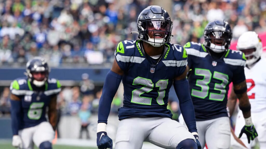 Devon Witherspoon Seattle Seahawks NFL action shot in navy neon uniform intense football game Wallpaper