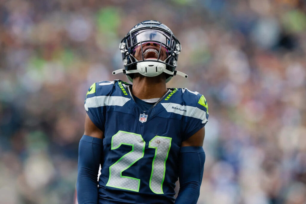 Devon Witherspoon Seattle Seahawks focused intense expression reflective visor football game Wallpaper