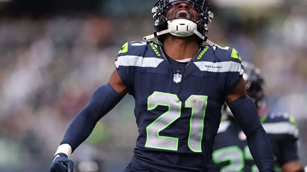 Devon Witherspoon celebrating on field wearing Seattle Seahawks navy and neon green uniform Wallpaper