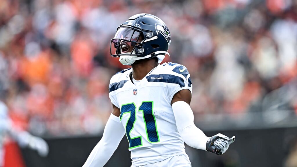 Devon Witherspoon number 21 in blue Seattle Seahawks uniform celebrating on field action shot Wallpaper