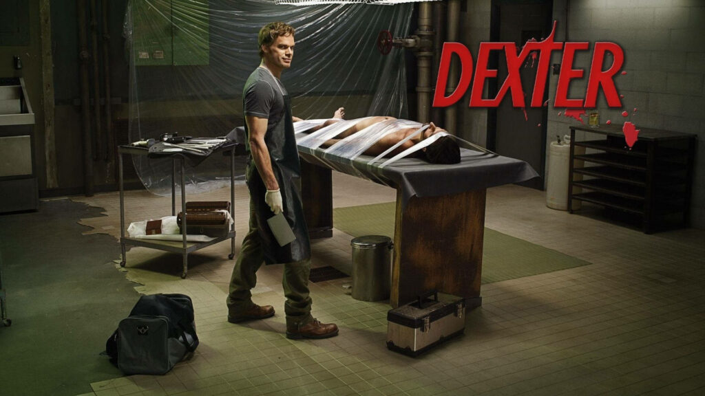 Michael C Hall as Dexter Morgan with knife in dim room beside victim on table dark suspense wallpaper