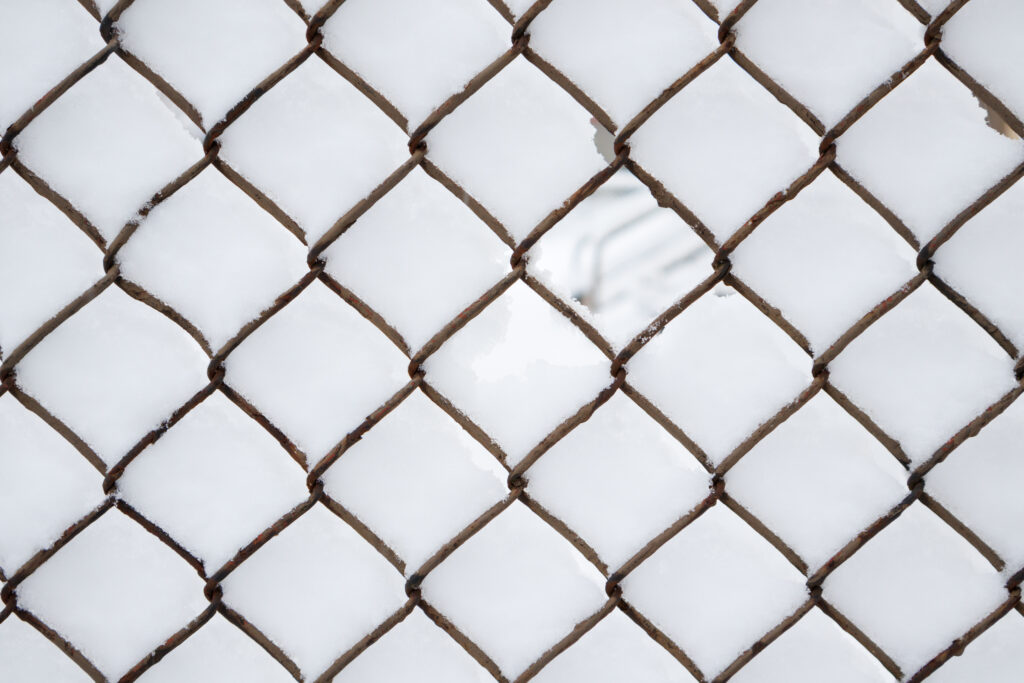 Diamond Pattern Wire Fence in Snow: Textured Wallpaper Background