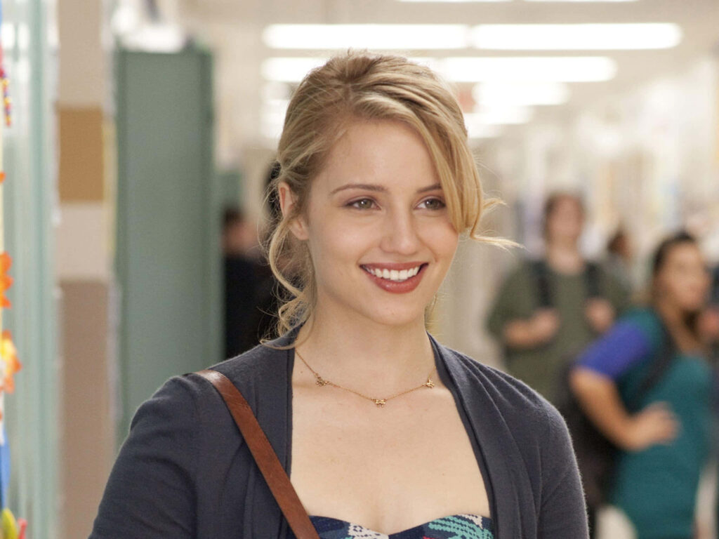Dianna Agron smiling in bright hallway with soft natural light and blurred background wallpaper