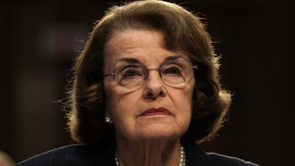 Dianne Feinstein close-up portrait with glasses in dark suit thoughtful expression wallpaper background