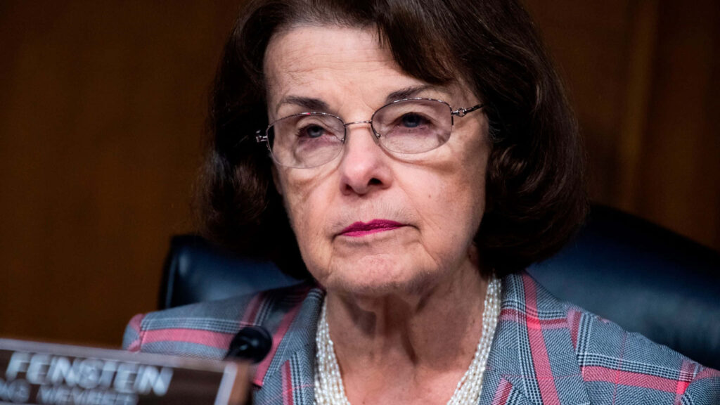 Close-up portrait of Dianne Feinstein in checked blazer and pearls with thoughtful expression wallpaper