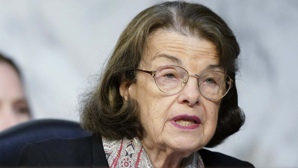Close-up portrait of Dianne Feinstein with thoughtful expression and signature glasses wallpaper