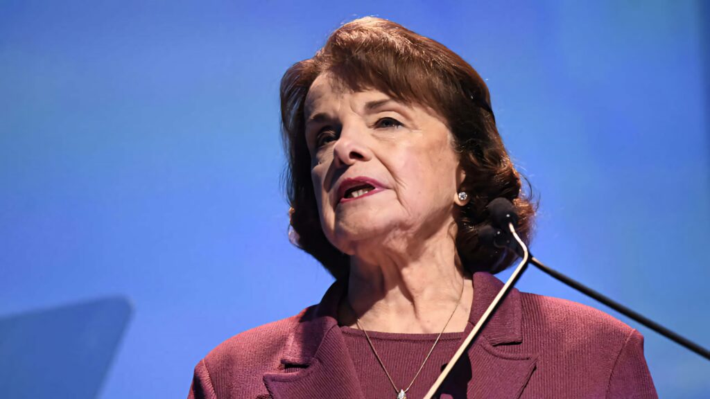 Dianne Feinstein portrait wallpaper with soft blue background showcasing leadership and service