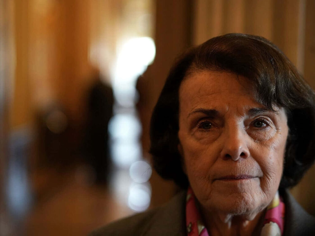 Dignified portrait of Dianne Feinstein with warm golden background highlighting leadership and resilience Wallpaper