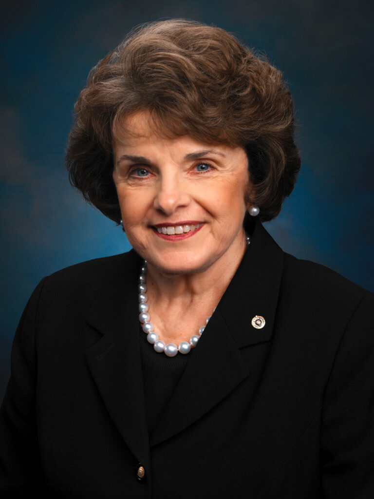 Dianne Feinstein professional portrait elegant black suit pearl necklace dark background wallpaper
