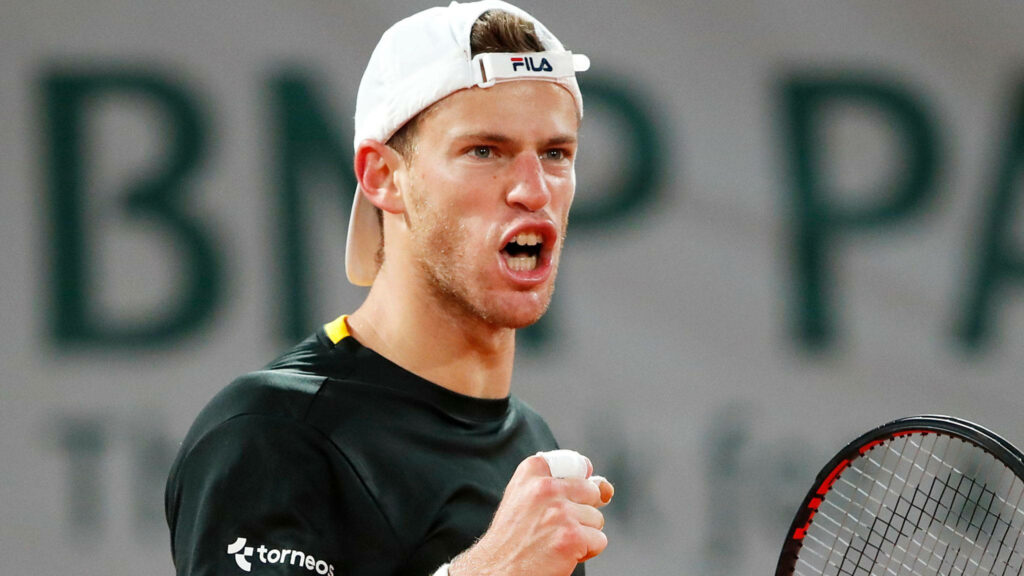 Diego Schwartzman shouting and clenching fist in intense tennis match showing passion and focus Wallpaper