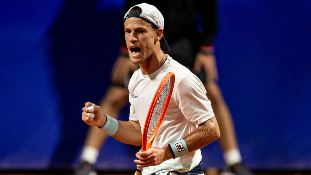 Diego Schwartzman celebrating on tennis court with orange racket intense athletic energy wallpaper