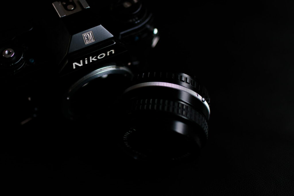 Capturing the Future: A Black Nikon DSLR on a Digital Wallpaper Background