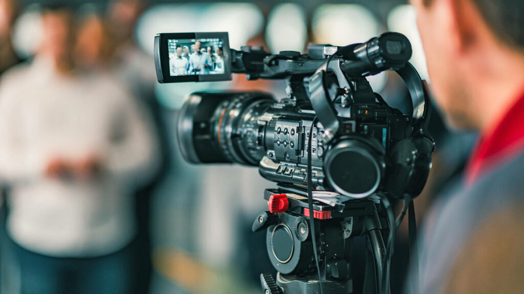 Capturing the Action: Digital Operator Behind the Scenes of a Production Shoot in Portrait Mode Wallpaper