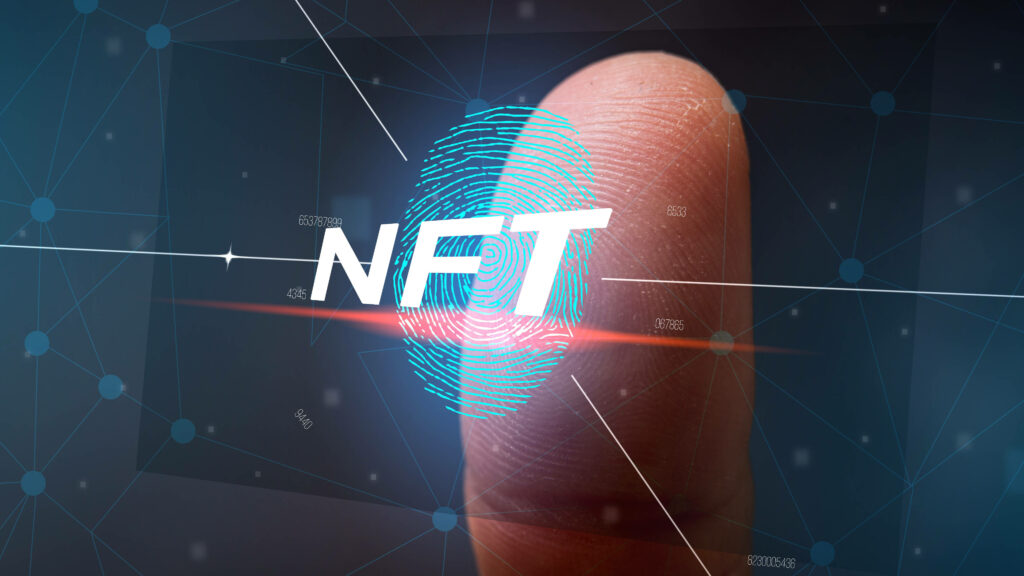 Close-up thumb with digital blue fingerprint and NFT text symbolizing unique digital identity security Wallpaper