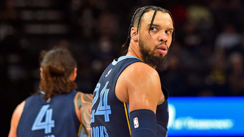 Dillon Brooks navy blue jersey intense focus mid game basketball court dynamic arena background Wallpaper
