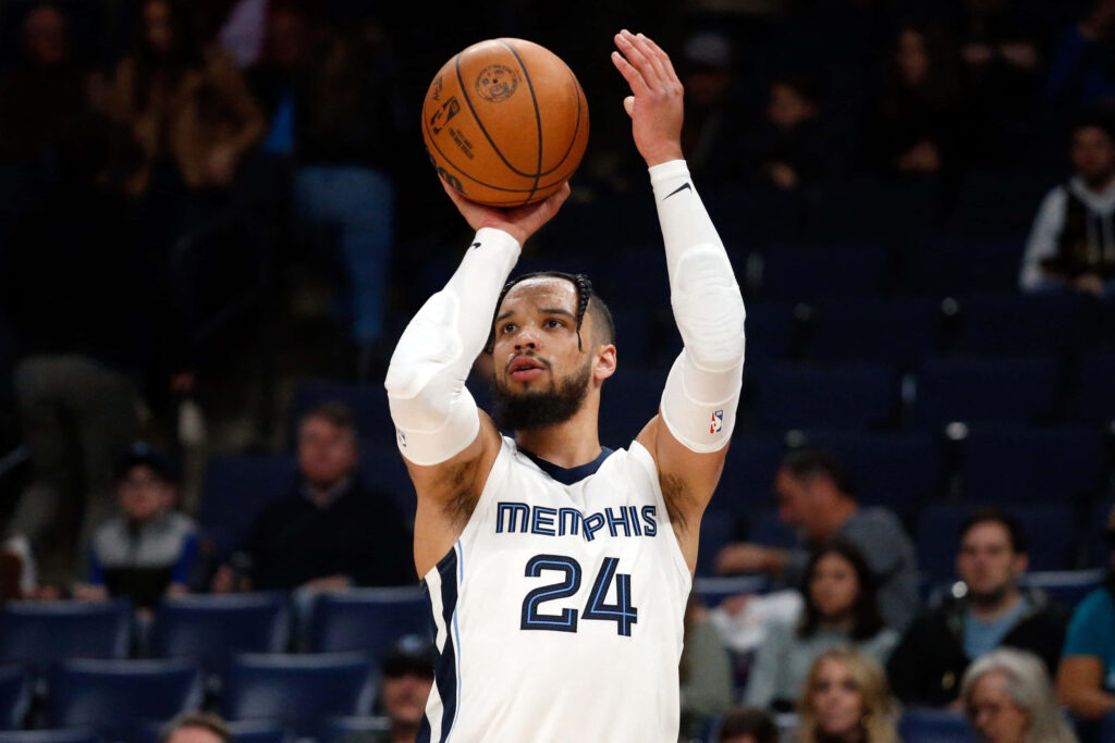 Dillon Brooks shooting basketball in Memphis jersey intense focus pro basketball stadium action Wallpaper