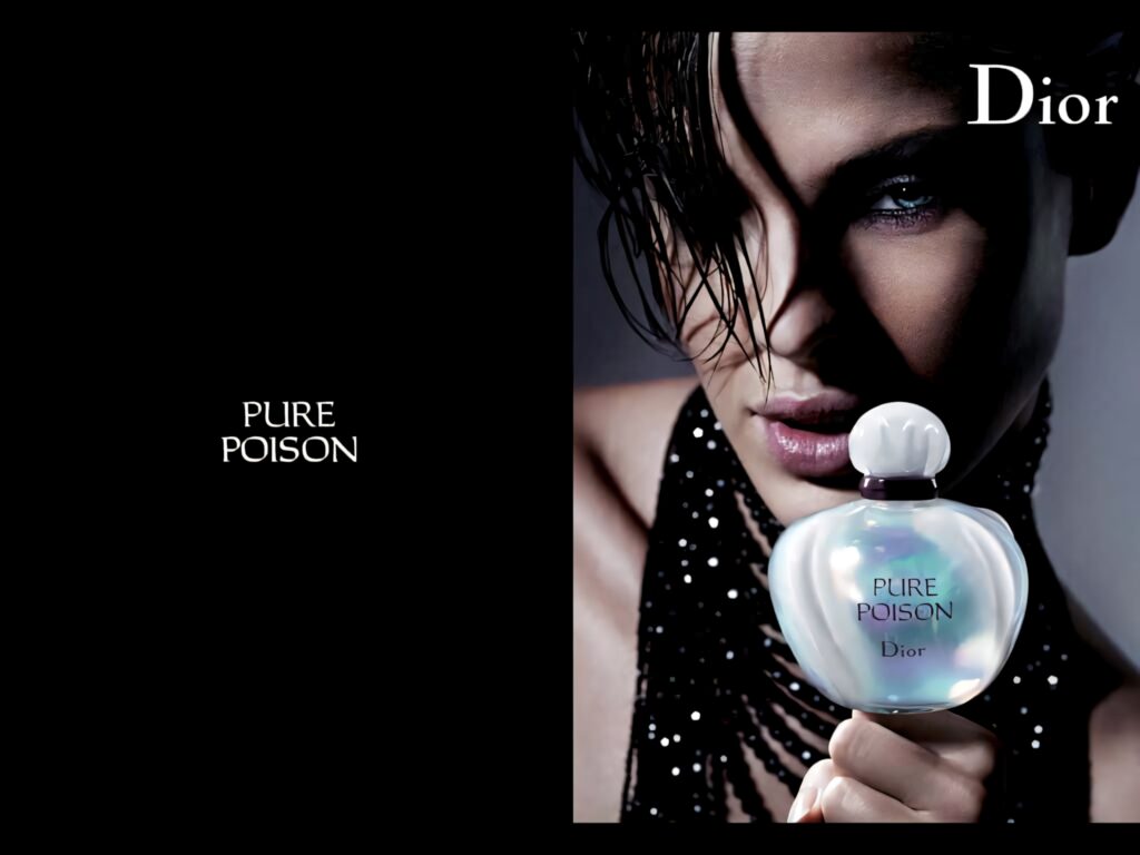 Striking model with wet hair holds shimmering Dior Pure Poison perfume against dark luxury background Wallpaper