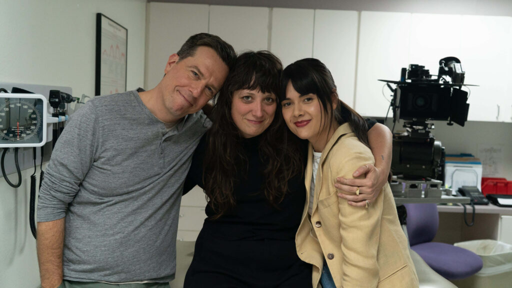 Director Nikole Beckwith with actors Ed Helms and Patti Harrison on Together Together film set behind scenes Wallpaper