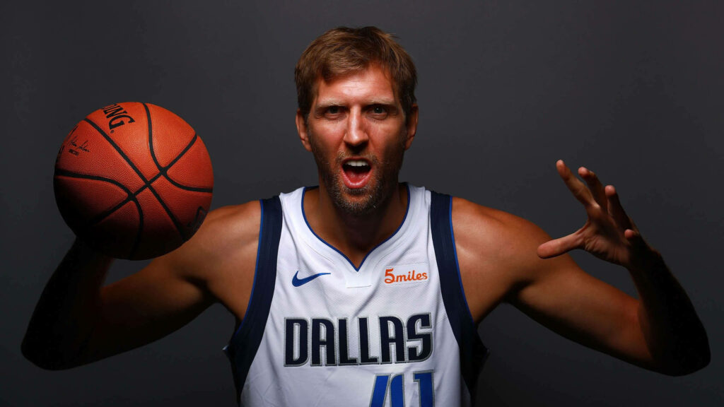 Dirk Nowitzki Dallas Mavericks portrait wallpaper holding basketball intense pose dark background