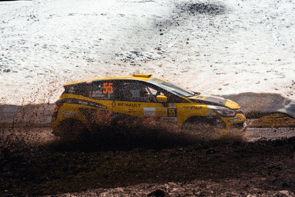 Speeding Yellow Dirt Racer: Capturing the Renault Mégane R.S. in Action on a Scenic Dirt Trail Wallpaper