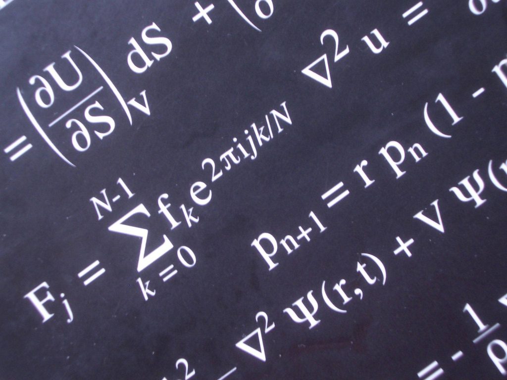 Wallpaper with complex physics equations including Discrete Fourier Transform in white on black