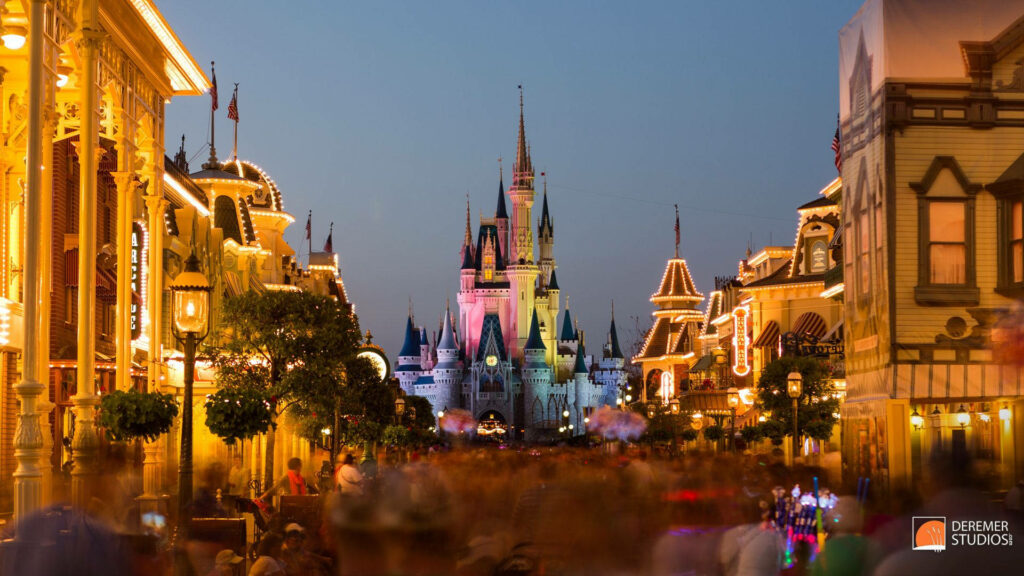 Disney Castle at twilight with glowing streetlights vibrant shops magical fairytale wallpaper background