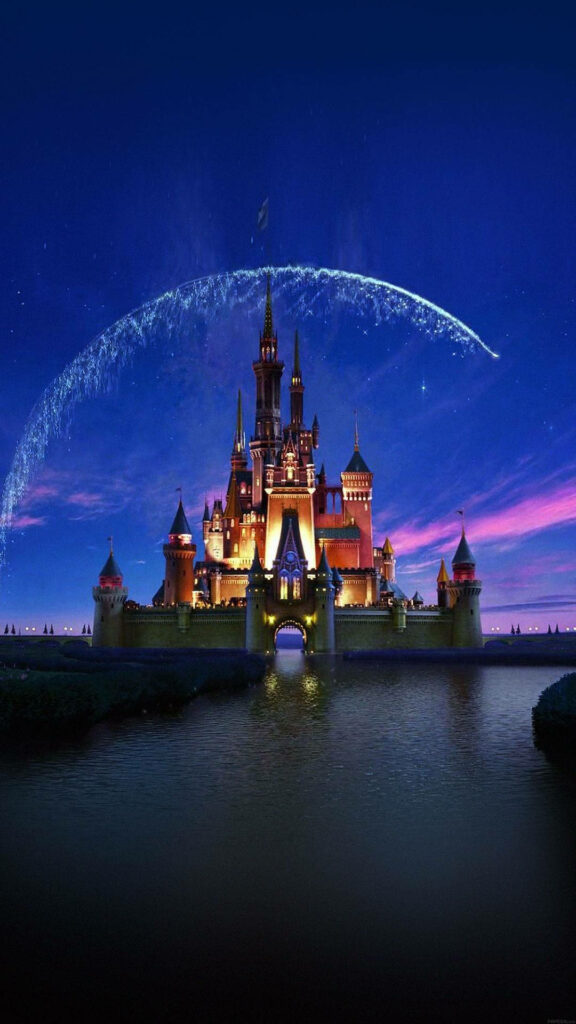 Disney Castle illuminated at twilight with blue purple sky and magical sparkling light arc wallpaper
