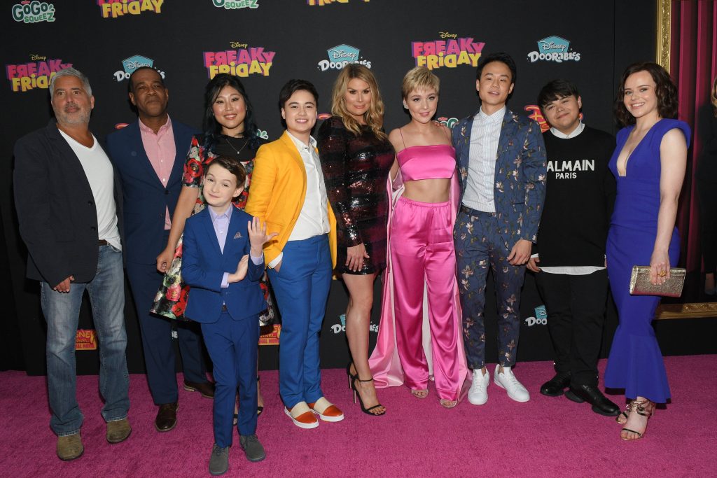 Disney Freaky Friday 2018 cast and director Steve Carr pose on pink carpet at film premiere Wallpaper