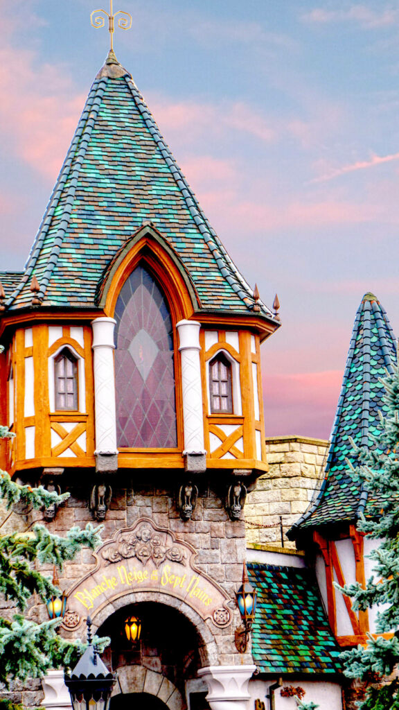 Disneyland Enchanted Window wallpaper castle with stained glass colorful rooftops pink sunset sky