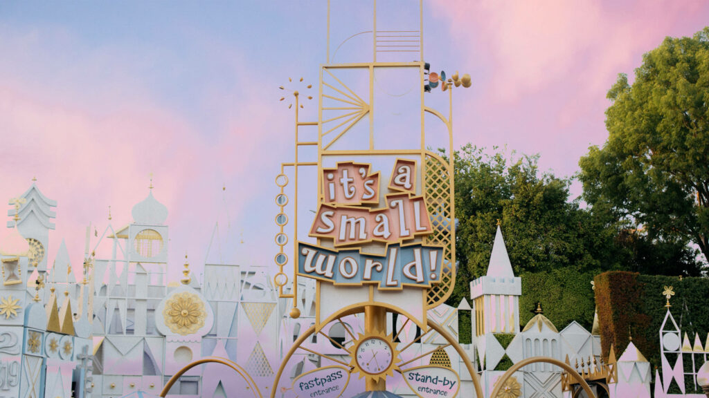 Disneyland vintage Its a Small World ride entrance wallpaper pastel sky nostalgic facade